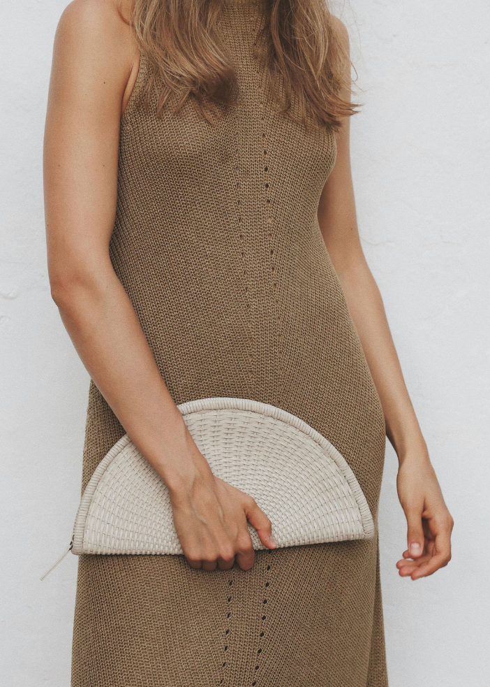 person wearing BEMBIEN Perla Clutch in Cream womens woven leather
