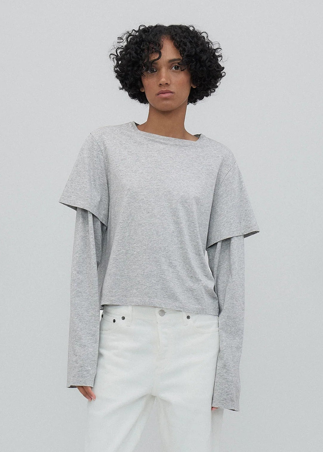 person wearing Still Here New York womens 2Tee long sleeve shirt in Heather Grey