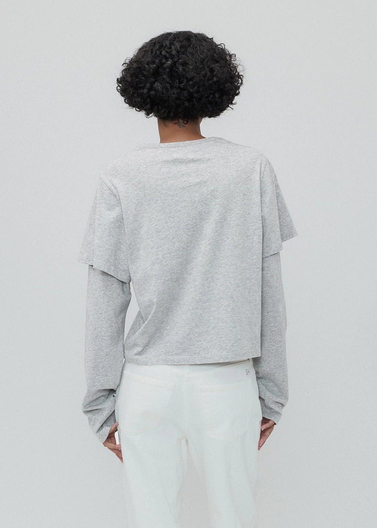 person wearing Still Here New York womens 2Tee long sleeve shirt in Heather Grey