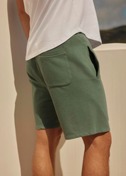 Person wearing Velvet Men's Beckett Sweatshorts in Shrub