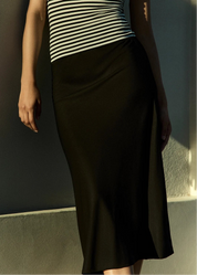 person wearing anemos womens Rey Bias-Cut Midi Skirt in Black stretch viscose