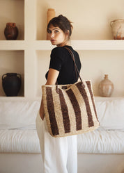 person wearing bembien womens raffia Françoise Tote in Brown Stripe