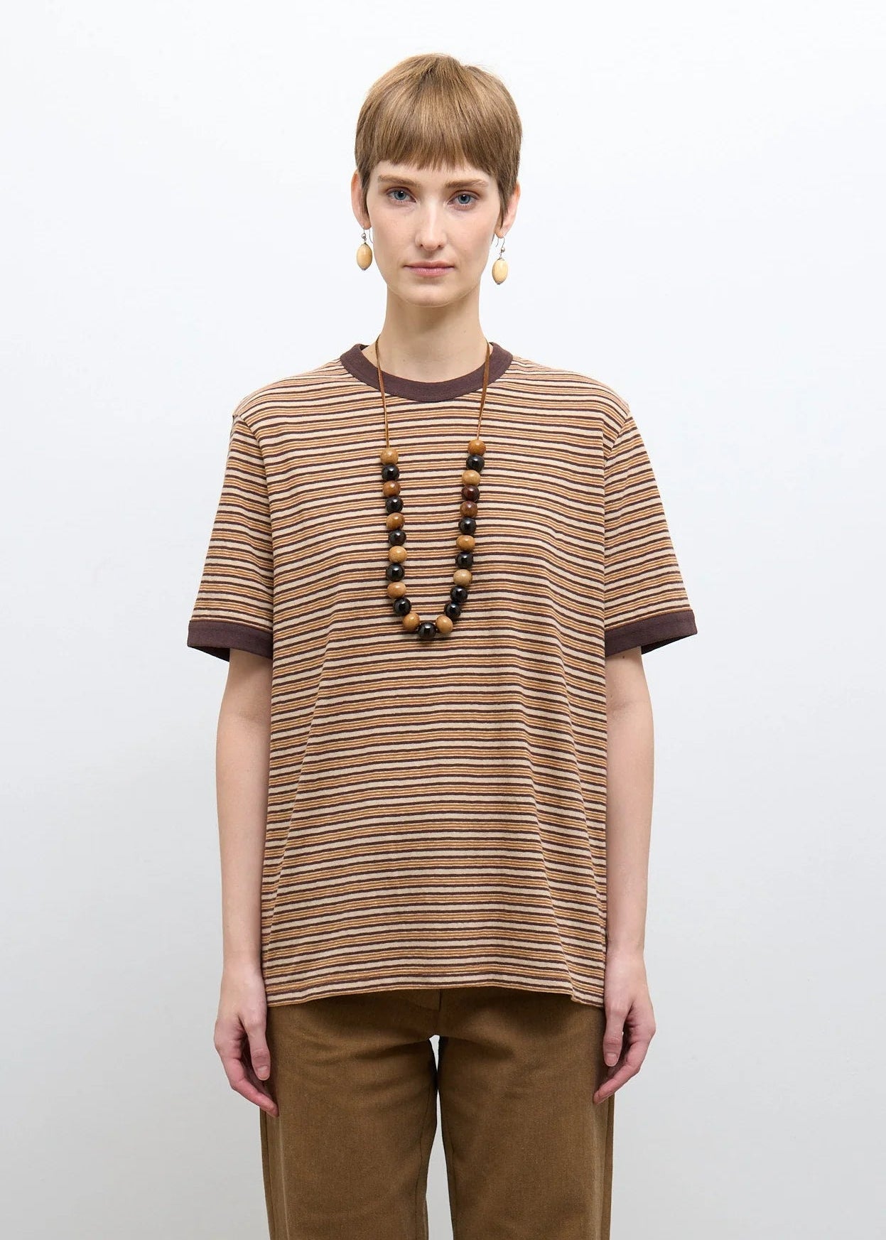 person wearing cawley studio Unisex Japanese Jersey Short Sleeve T-Shirt in Brown Stripe