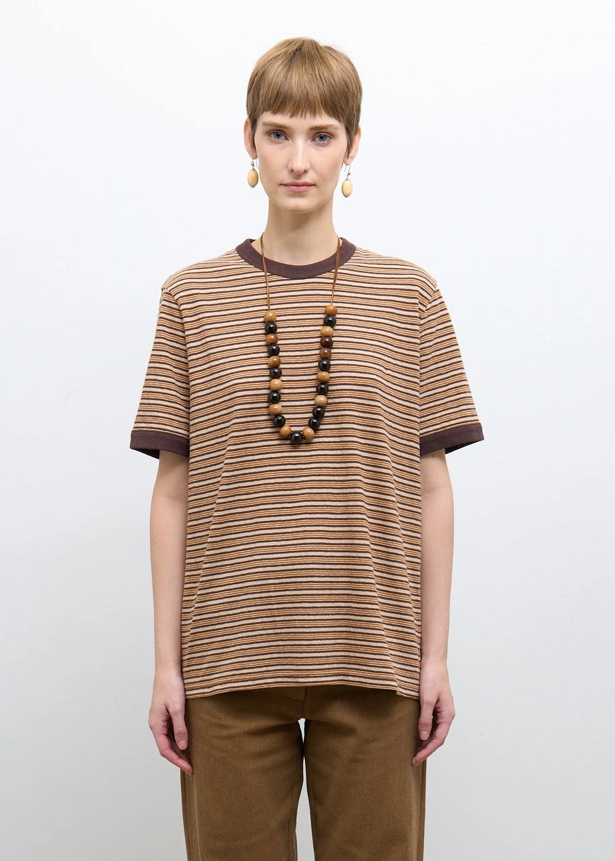 person wearing cawley studio Unisex Japanese Jersey Short Sleeve T-Shirt in Brown Stripe