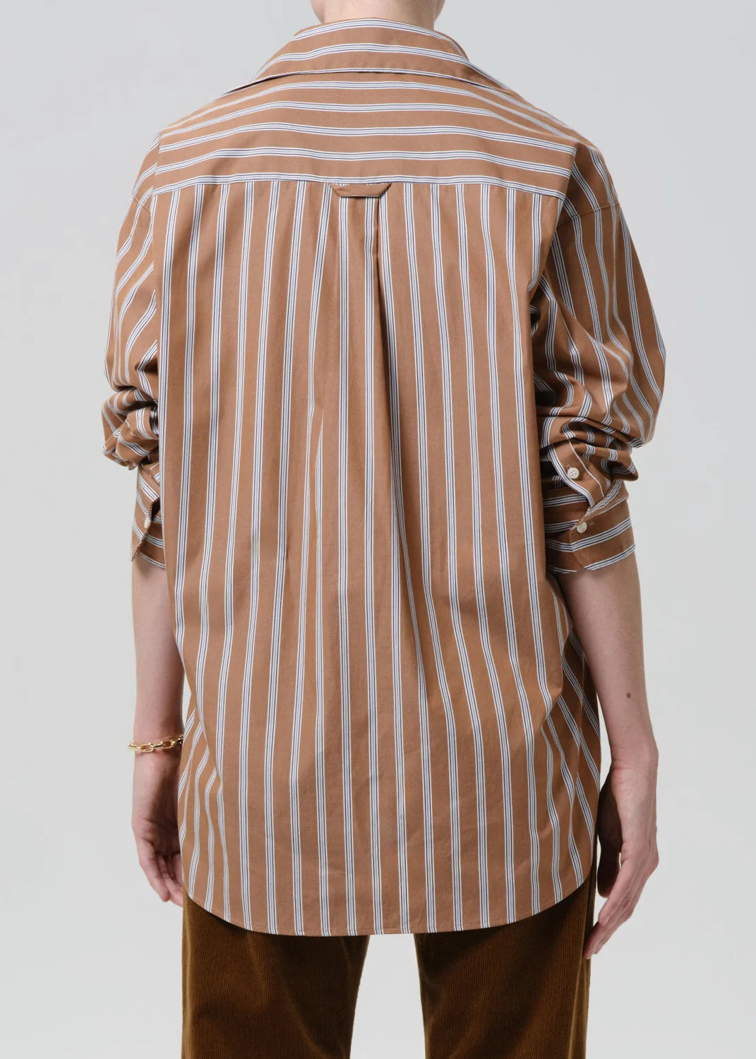 person wearing citizens of humanity womens japanese cotton Thea Boyfriend Shirt In Copper Stripe