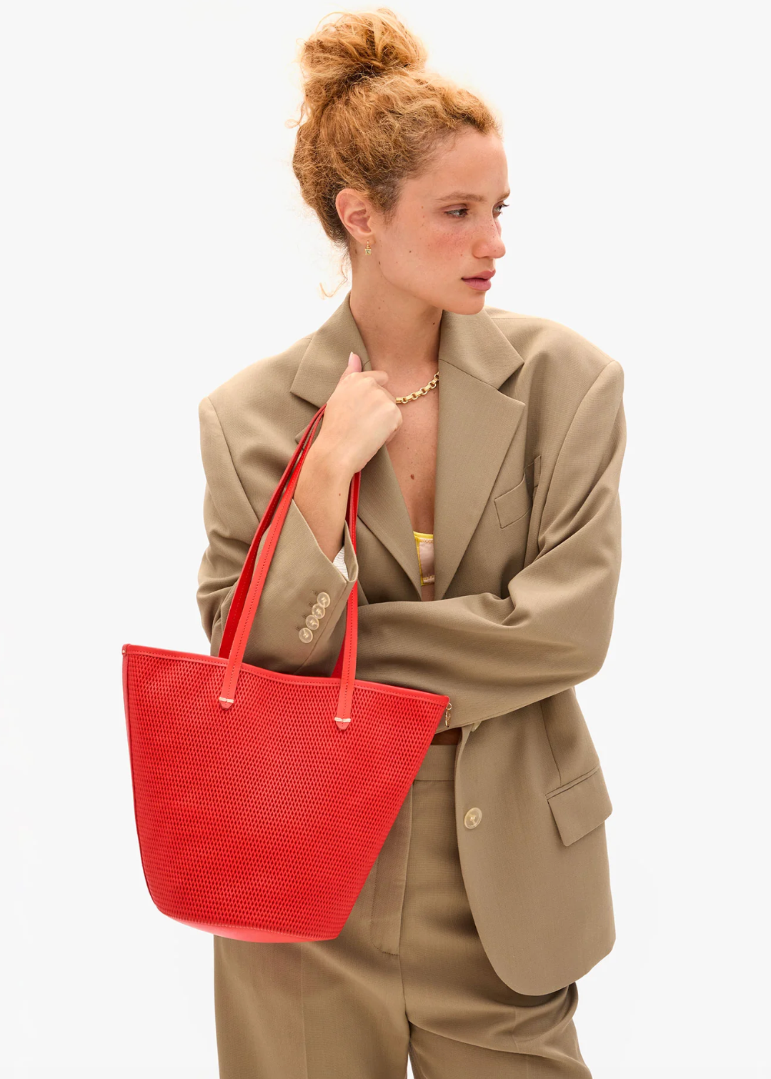 person wearing clare v Choupette Bucket Bag in Bright Poppy