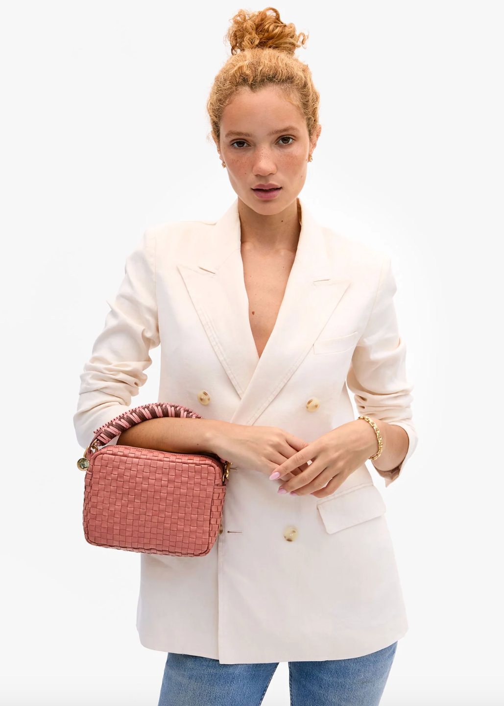person carrying clare v womens Midi Sac in Rose Clay Woven Checker crossbody bag with mulberry braided top handle