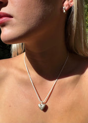 person wearing dunton ellerkamp jewelry American Folk Heart Pendant Necklace silver foxtail chain