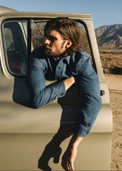 person wearing hiroshi kato mens The Brace Shirt 7oz Denim Shirt in Craig Wash