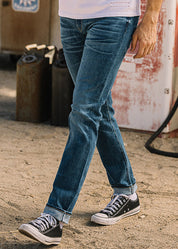 person wearing hiroshi kato mens The Pen Slim Straight Ace 10.5oz Stretch Selvedge Denim Jeans