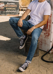 person wearing hiroshi kato mens The Pen Slim Straight Ace 10.5oz Stretch Selvedge Denim Jeans