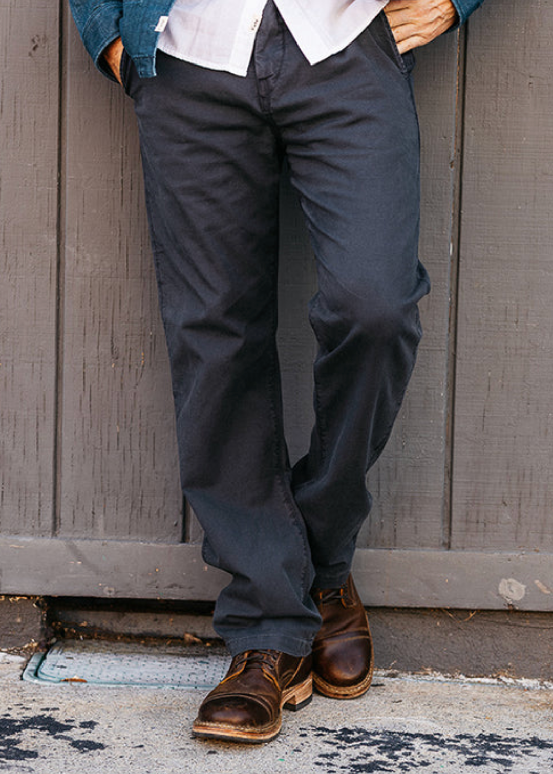 person wearing hiroshi kato mens The Pipe Straight Oxford Chino in Ash Black