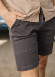 person wearing hiroshi kato mens The Scout 8" Denit® Fatigue Shorts in Iron Gray