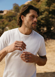person wearing hiroshi kato mens The Stamp 9oz Organic Cotton Tee in Shell