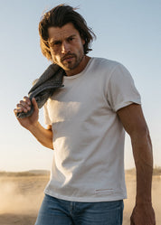 person wearing hiroshi kato mens The Stamp 9oz Organic Cotton Tee in Shell