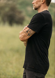 person wearing hiroshi kato mens The Stamp Double Knit Tee in Black
