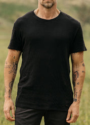 person wearing hiroshi kato mens The Stamp Double Knit Tee in Black