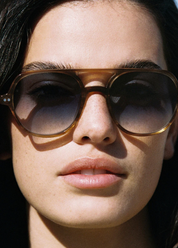 person wearing jimmy fairly paris unisex sunglasses The Lars in Light Brown blue gradient lenses