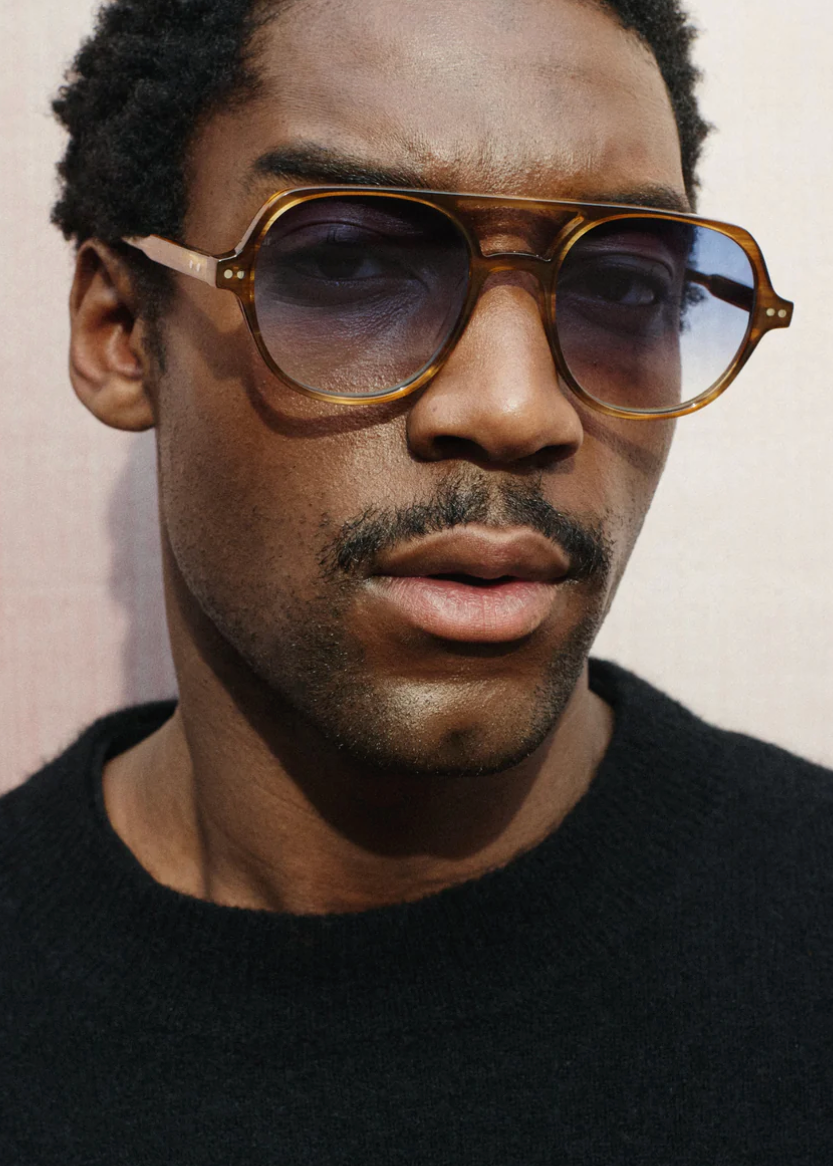 person wearing jimmy fairly paris unisex sunglasses The Lars in Light Brown blue gradient lenses