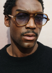 person wearing jimmy fairly paris unisex sunglasses The Lars in Light Brown blue gradient lenses