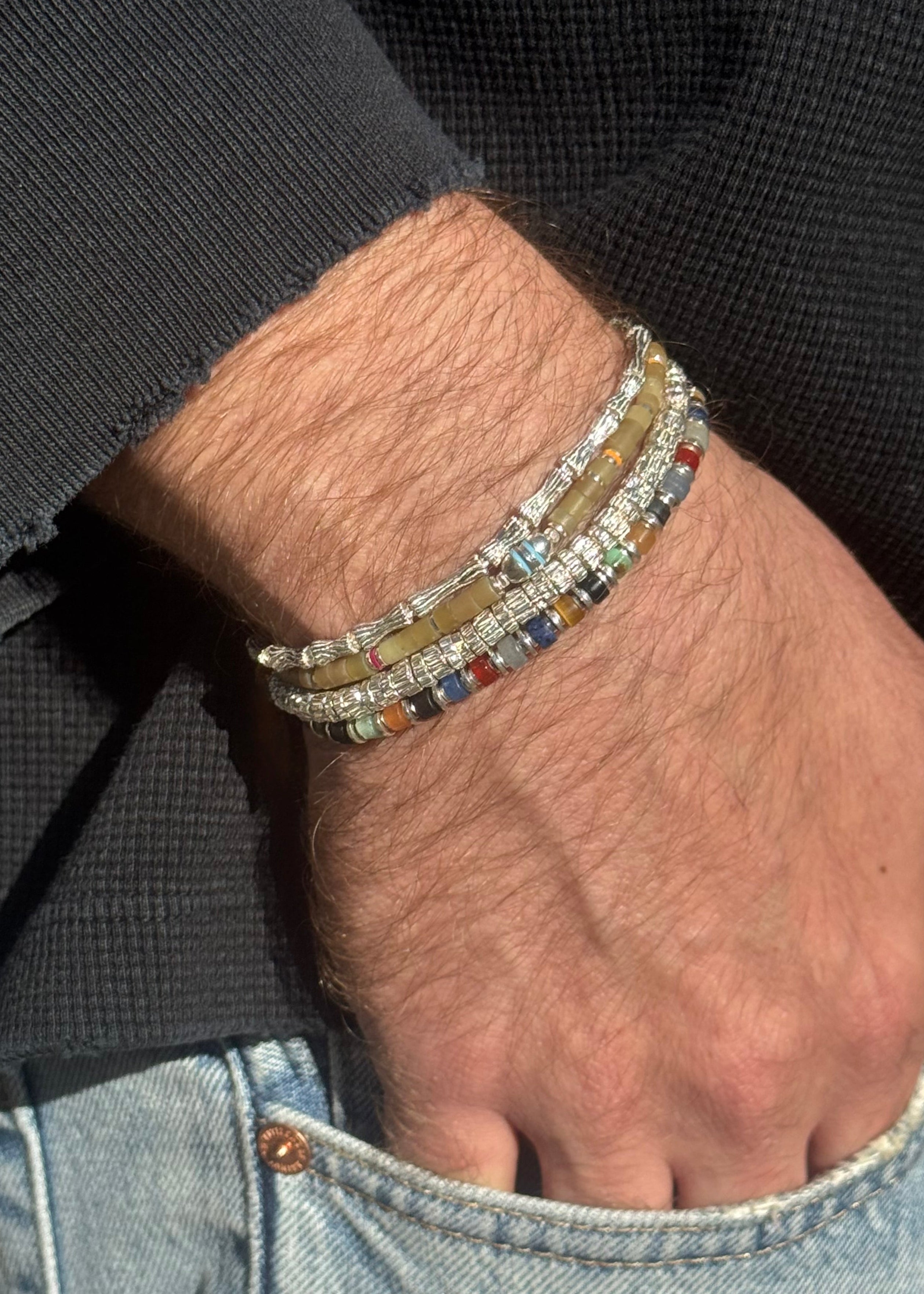 person wearing maor mens jewelry Mixed Gem Sapet Bracelet in Silver Woody Bracelet in Silver Beige green Jade Cherish Bracelet in Silver Small Timor Bracelet in Silver