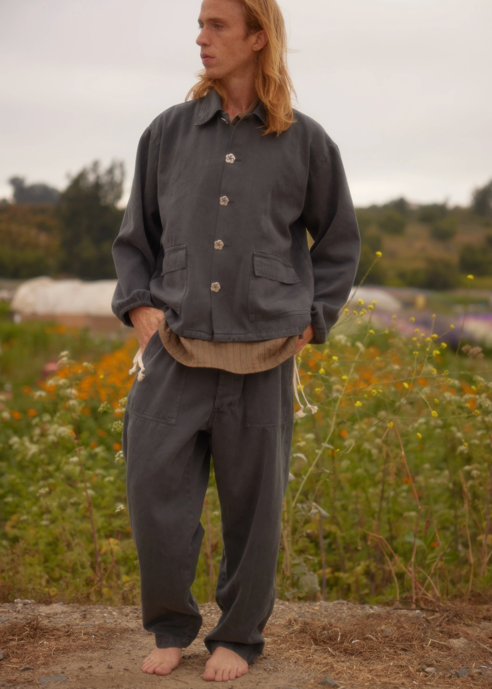 person wearing monostereo mens "Community of Lovers" Work Jacket in Washed Black and "Community of Lovers" Hemp Pants in Washed Black