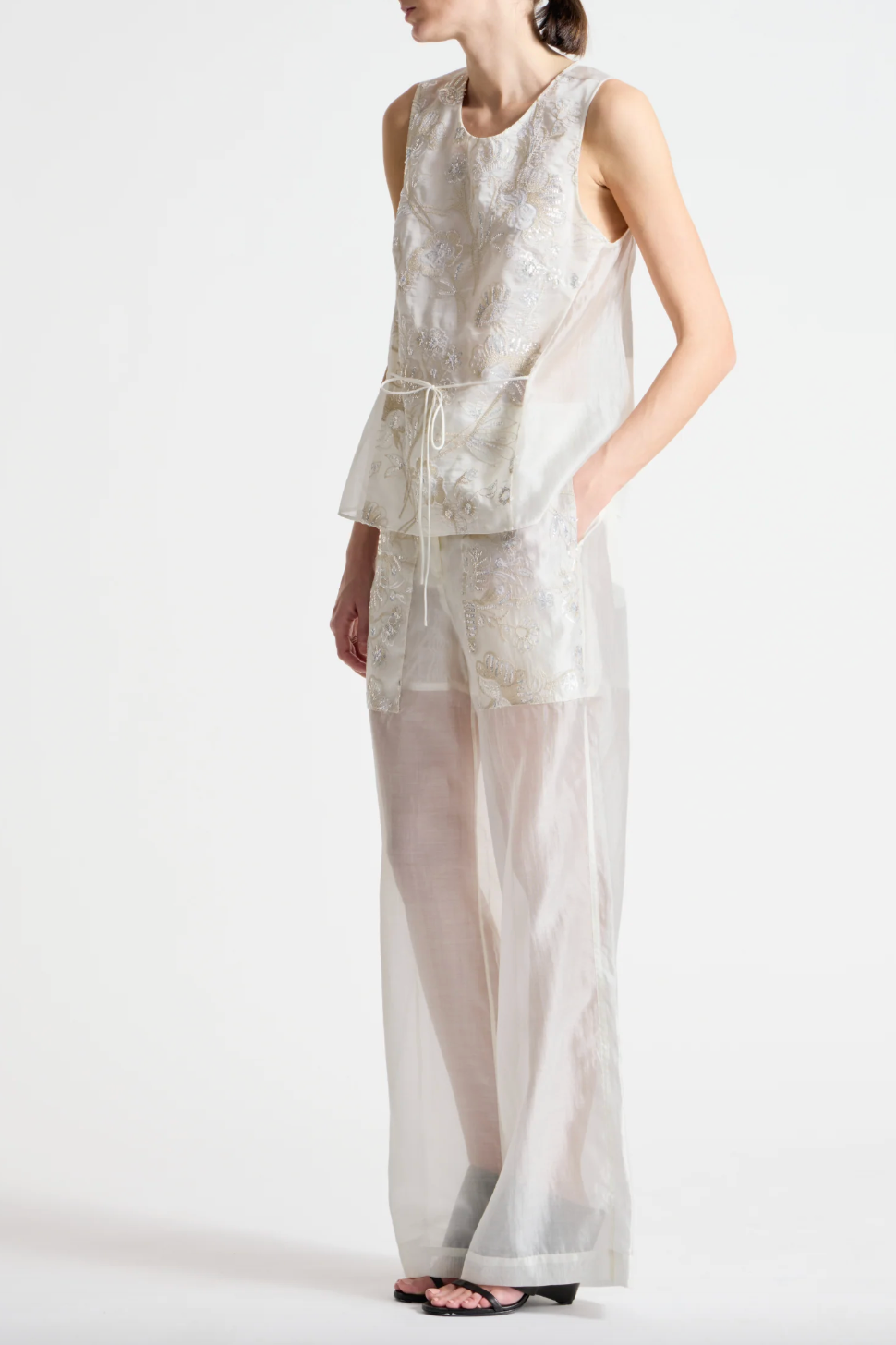 person wearing person wearing saint art womens Benson Floral Sequin Blouse and Sequin Hewes Pants in Ivory