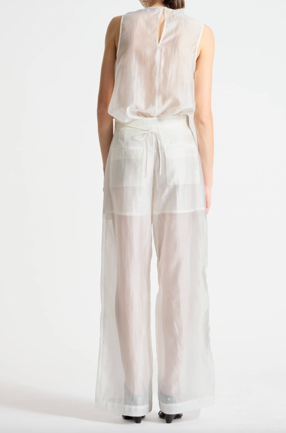 person wearing person wearing saint art womens Benson Floral Sequin Blouse and Sequin Hewes Pants in Ivory