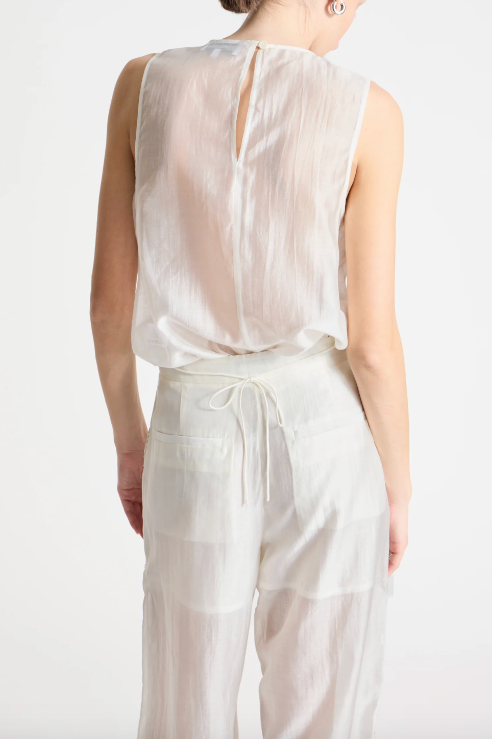 person wearing person wearing saint art womens Benson Floral Sequin Blouse and Sequin Hewes Pants in Ivory
